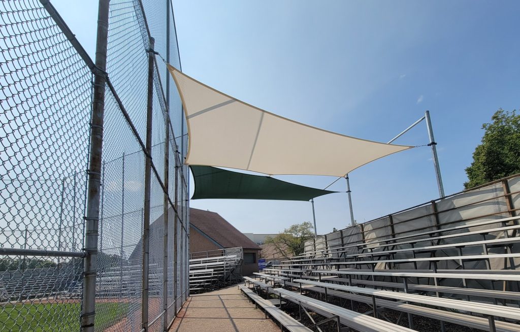 20240814_144026 Green and cream shade sails over baseball bleachers in Kitchener Ontario