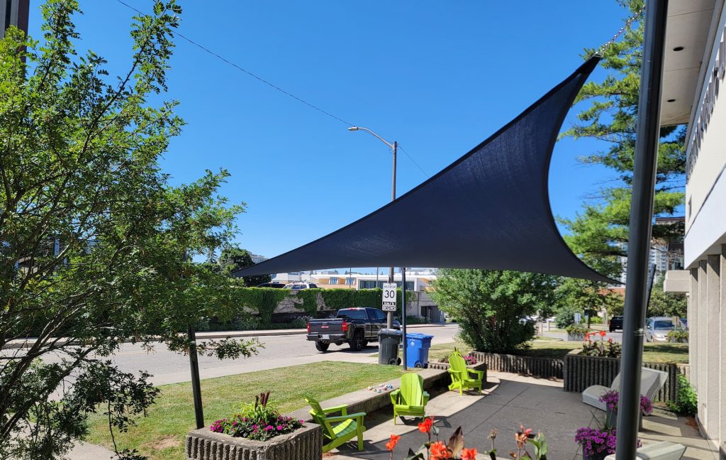20250718_110333 Navy shade sail Waterloo Public Library public gathering area Ontario