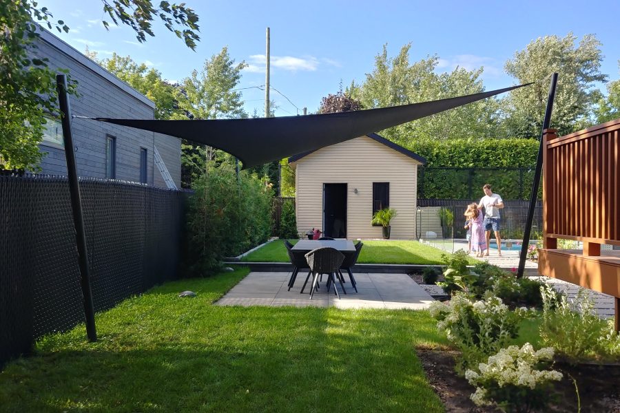 Plan your shade sail: charcoal shade sail over an Ontario dining patio on a sunny day